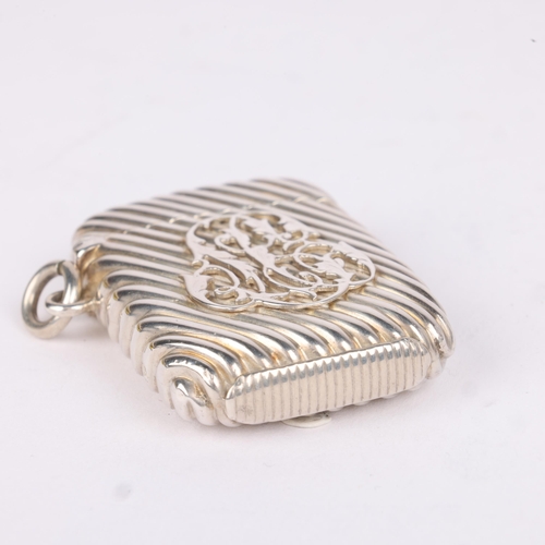 24 - SAMPSON MORDAN & CO - a Victorian silver Vesta case, London 1886, rectangular form with allover flut... 