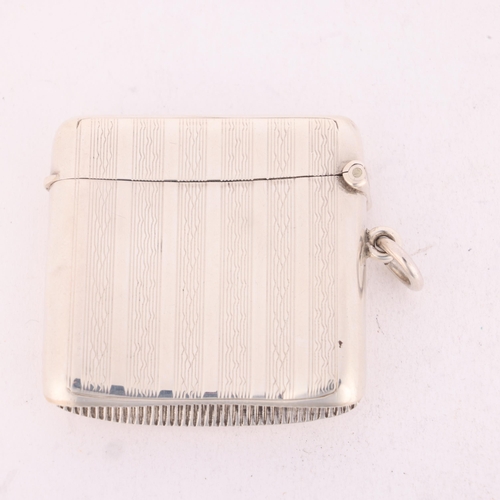 256 - An Edwardian silver Vesta case, Deakin & Francis, Birmingham 1904, curved square form with allover e... 