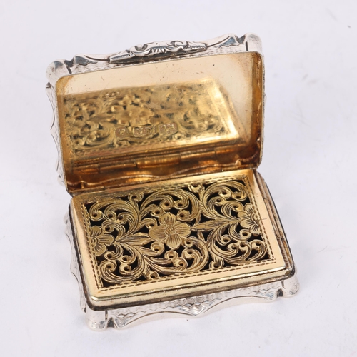 50 - NATHANIEL MILLS - an early Victorian silver vinaigrette, Birmingham 1844, shaped rectangular form wi... 