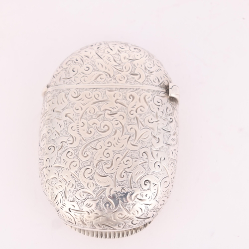 9 - SAMPSON MORDAN & CO - a Victorian silver 'Chunky' Vesta case, London 1892, oval form with allover ch... 