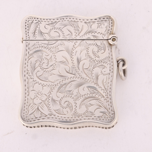 98 - A George V silver Vesta case, HM & Coy, Birmingham 1911, shaped rectangular form with engraved folia... 