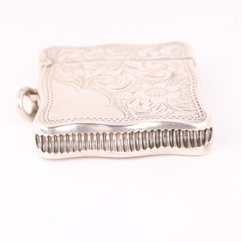 98 - A George V silver Vesta case, HM & Coy, Birmingham 1911, shaped rectangular form with engraved folia... 