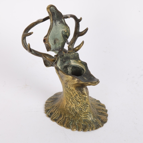 21 - Victorian brass deer's head design inkwell, with pen rest antlers, hinged lid and glass eyes, height... 