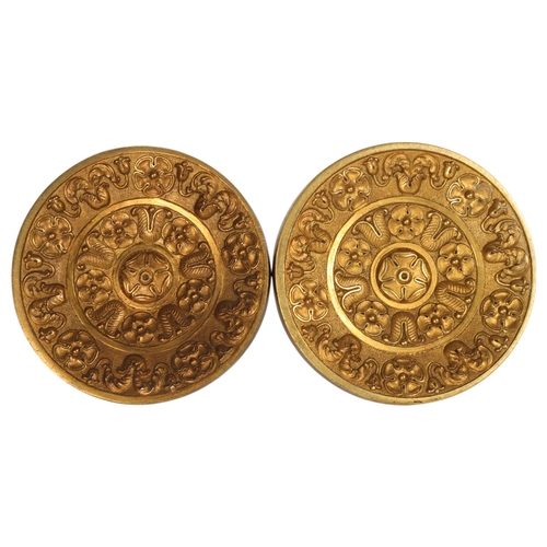 253 - A pair of Victorian cast and chased gilded brass curtain tidies, diameter 9.5cm