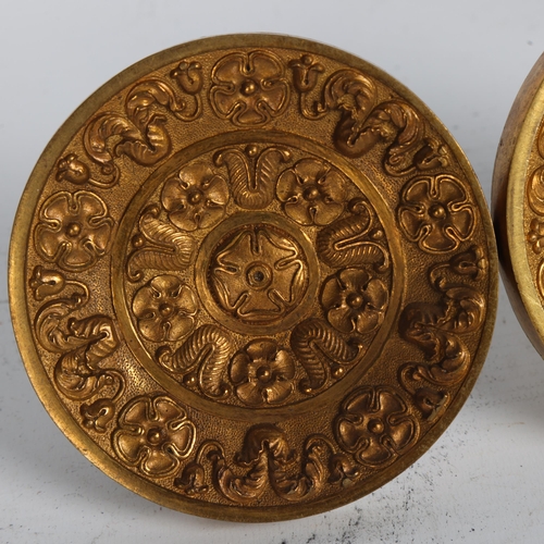 253 - A pair of Victorian cast and chased gilded brass curtain tidies, diameter 9.5cm