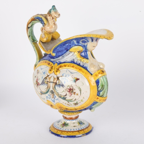 6 - An Italian Maiolica ewer, 19th century, with griffon handle and hand painted panel, signed under bas... 