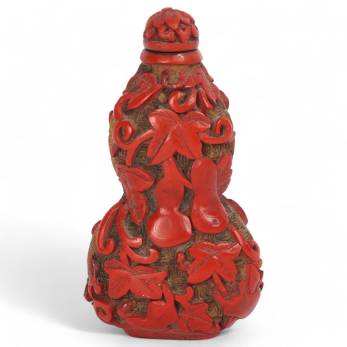 85 - A Chinese relief carved cinnabar double-gourd snuff bottle and stopper, Qing Dynasty, height 8.5cm