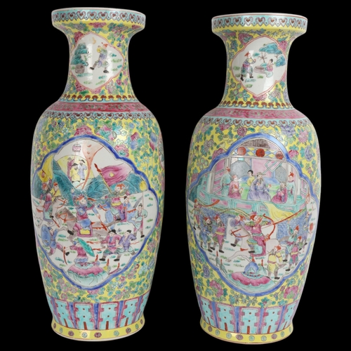 87 - A pair of Chinese famille jeaune porcelain vases, with enamel decorated panels, height 59cm