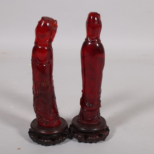 42 - 2 similar Chinese amber figures on carved wood bases, height 32cm