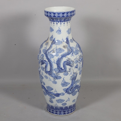 45 - A large Chinese blue and white porcelain vase, with relief moulded dragons, height 91cm