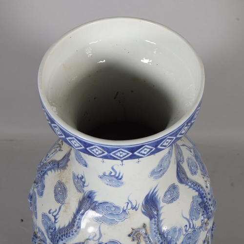 45 - A large Chinese blue and white porcelain vase, with relief moulded dragons, height 91cm