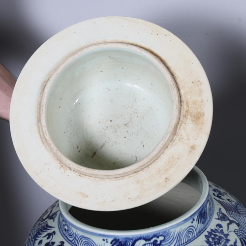 47 - A large pair of Chinese blue and white porcelain jars and covers, with dragon decoration and dog of ... 