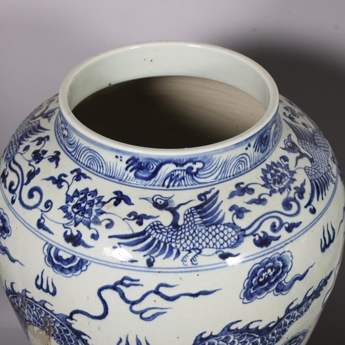 47 - A large pair of Chinese blue and white porcelain jars and covers, with dragon decoration and dog of ... 