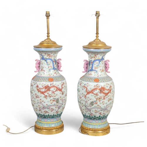 48 - A pair of Chinese famille rose porcelain lamps, with enamel dragon decoration and gilt-metal mounts,... 