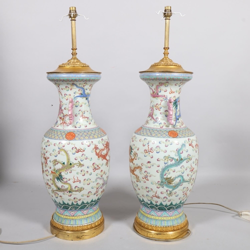 48 - A pair of Chinese famille rose porcelain lamps, with enamel dragon decoration and gilt-metal mounts,... 