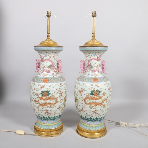 48 - A pair of Chinese famille rose porcelain lamps, with enamel dragon decoration and gilt-metal mounts,... 