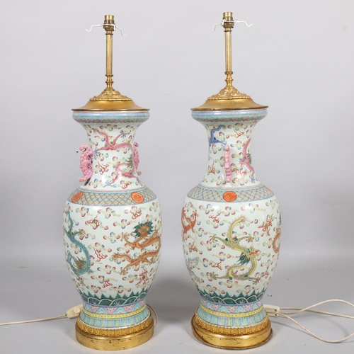 48 - A pair of Chinese famille rose porcelain lamps, with enamel dragon decoration and gilt-metal mounts,... 