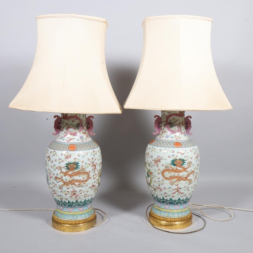 48 - A pair of Chinese famille rose porcelain lamps, with enamel dragon decoration and gilt-metal mounts,... 