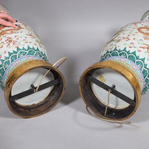 48 - A pair of Chinese famille rose porcelain lamps, with enamel dragon decoration and gilt-metal mounts,... 