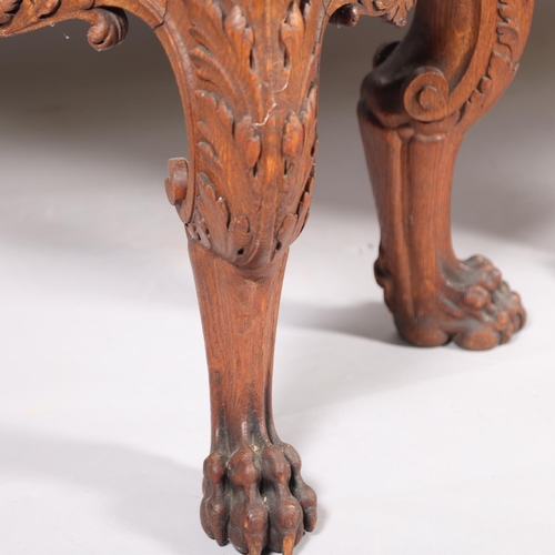 51 - A near pair of massive Chinese patinated bronze planters on oak stands, with elephant and dragon han... 