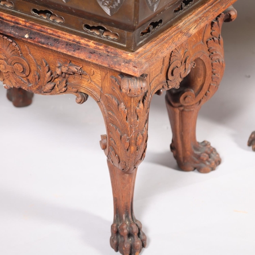 51 - A near pair of massive Chinese patinated bronze planters on oak stands, with elephant and dragon han... 