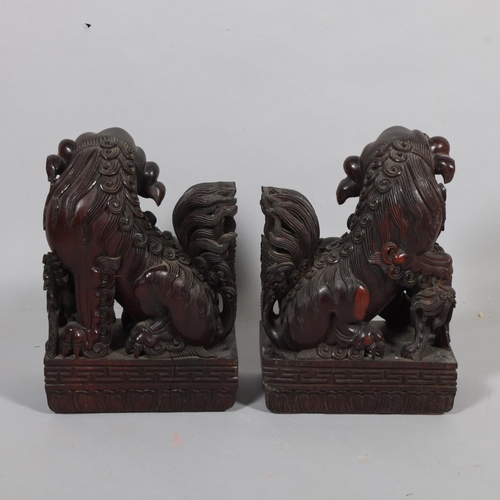 59 - **Withdrawn** A pair of Chinese 20th century carved hardwood dogs of fo, height 37cm, base length 26... 