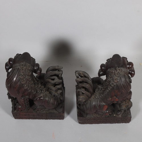 59 - **Withdrawn** A pair of Chinese 20th century carved hardwood dogs of fo, height 37cm, base length 26... 