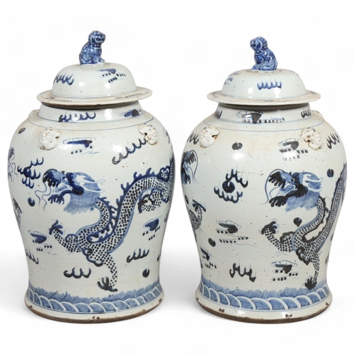 61 - A pair of Chinese blue and white jars and covers, with dragon decoration, height 55cm