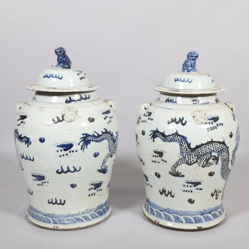 61 - A pair of Chinese blue and white jars and covers, with dragon decoration, height 55cm