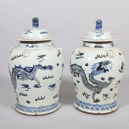 61 - A pair of Chinese blue and white jars and covers, with dragon decoration, height 55cm