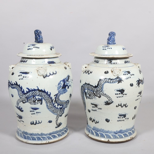 61 - A pair of Chinese blue and white jars and covers, with dragon decoration, height 55cm