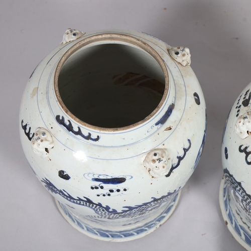 61 - A pair of Chinese blue and white jars and covers, with dragon decoration, height 55cm