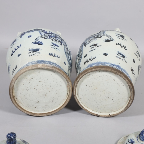 61 - A pair of Chinese blue and white jars and covers, with dragon decoration, height 55cm