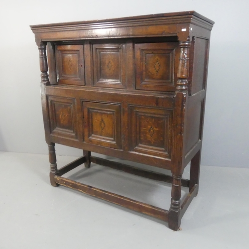 2142 - An 18th century panelled oak court cupboard. Width 138cm, height 151cm, depth 60cm.