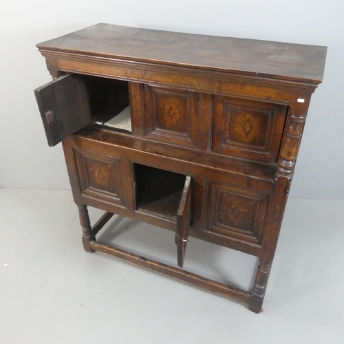 2142 - An 18th century panelled oak court cupboard. Width 138cm, height 151cm, depth 60cm.