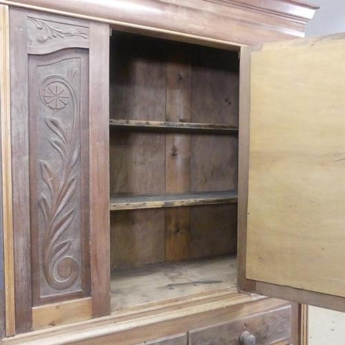 2148 - An Art Nouveau style two-section pine cabinet on chest, with single mirrored door, carved decoration... 