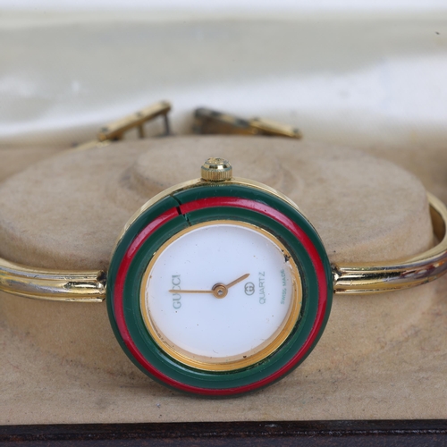 1029 - GUCCI - a Vintage gold plated stainless steel quartz bangle wristwatch, ref. 1100-L, circa 1988, whi... 