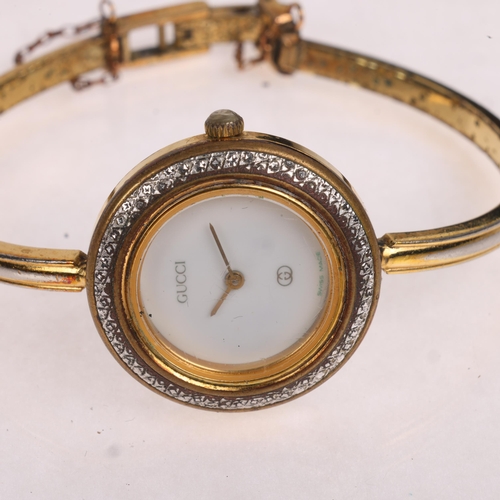 1037 - GUCCI - a lady's Vintage gold plated stainless steel quartz bangle wristwatch, ref. 1100-L, white di... 