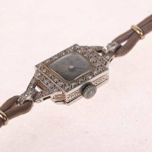 1060 - A lady's Art Deco platinum diamond mechanical cocktail wristwatch, by Isis, circa 1920s, silvered di... 