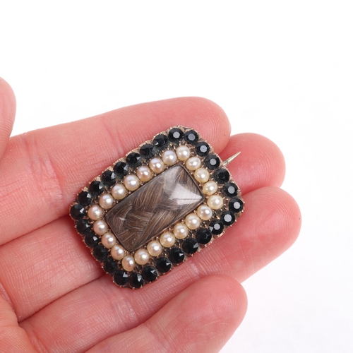 1214 - An Antique Georgian hairwork split pearl and French jet mourning brooch, circa 1820, the central wov... 