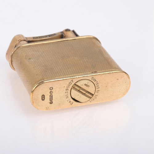 1222 - ALRED DUNHILL - an Art Deco 9ct gold lighter, maker AD, London 1946, oval form with allover engine t... 