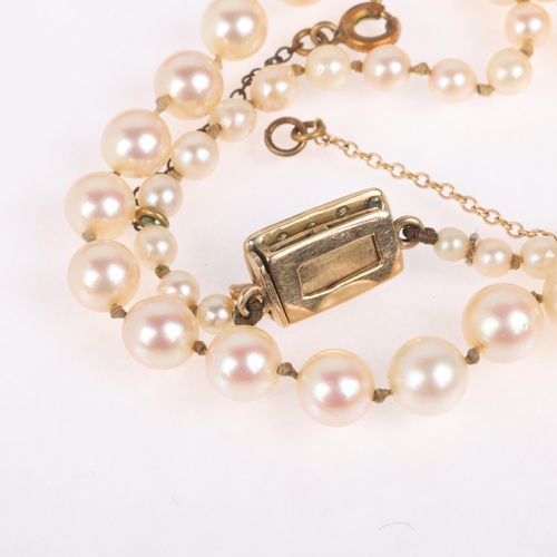 1226 - A single-strand pearl bead necklace, set with 8.1-3.3mm pearls, with 9ct gold synthetic? sapphire an... 