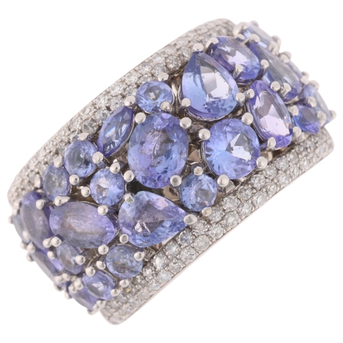 1228 - A 14ct white gold tanzanite and diamond band ring, by Effy, set with vari-cut tanzanites flanked by ... 