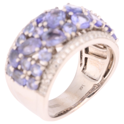 1228 - A 14ct white gold tanzanite and diamond band ring, by Effy, set with vari-cut tanzanites flanked by ... 