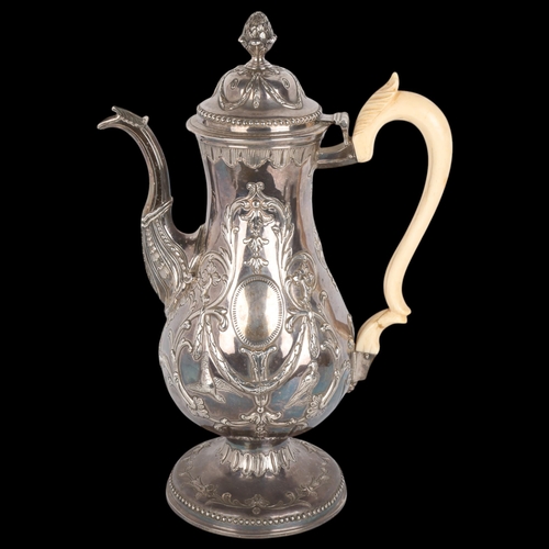 1762 - A Georgian Irish silver coffee pot, indistinct hallmarks, Dublin assay, baluster form with relief em... 