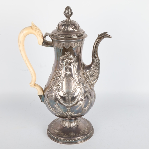 1762 - A Georgian Irish silver coffee pot, indistinct hallmarks, Dublin assay, baluster form with relief em... 