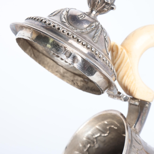 1762 - A Georgian Irish silver coffee pot, indistinct hallmarks, Dublin assay, baluster form with relief em... 