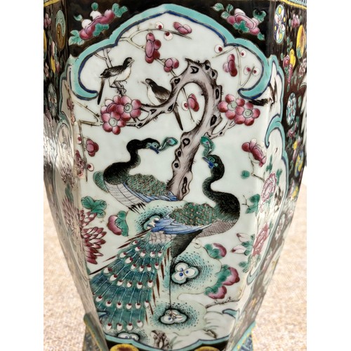 55 - A pair of Chinese porcelain vases, bulbous hexagonal form with pomegranate handles and enamelled dec... 