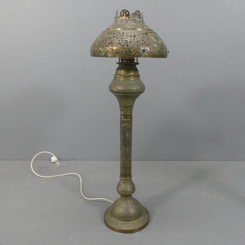 2051 - A 19th century Middle-Eastern Moorish pierced and chased brass floor lamp, converted from an oil lam... 