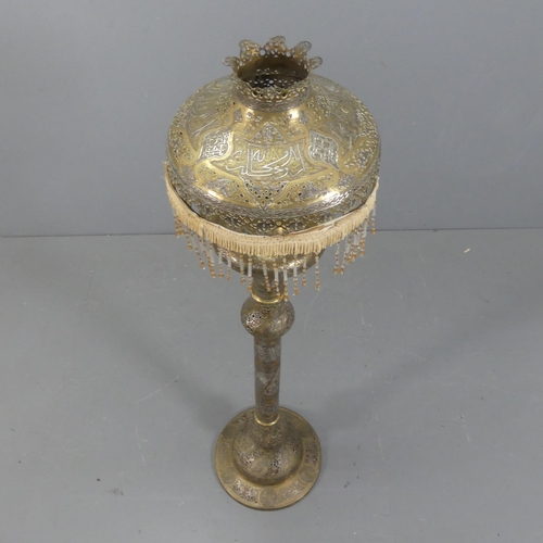 2053 - A middle-eastern floor standing oil lamp and shade. Height overall 153cm.